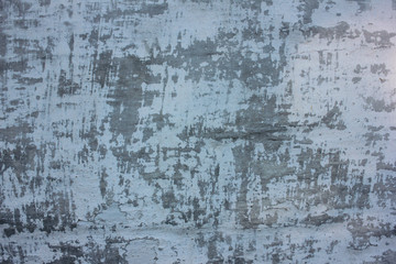 Grunge wall textured background. Old gray and white wall covered with shabby peeling plaster