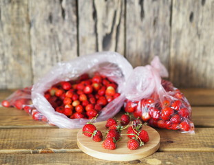 Packages with strawberries for storage in the freezer for future use.Food background with autumn strawberries.