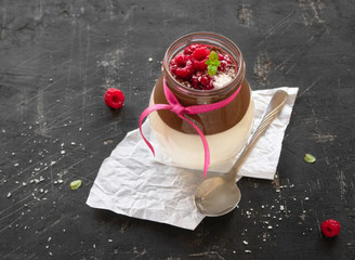 Curd dessert jar. Cottage cheese mousse with chocolate sauce and raspberries in a glass jar with a...