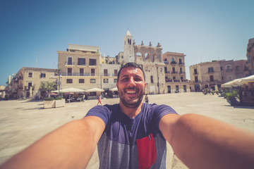 Happy tourist man take selfie in the old city of Bari, Puglia region. Italy
