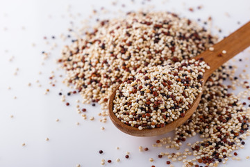 mix of quinoa grains on white acrylic background