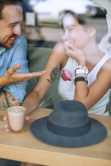 Shy woman and speaking man in cafe