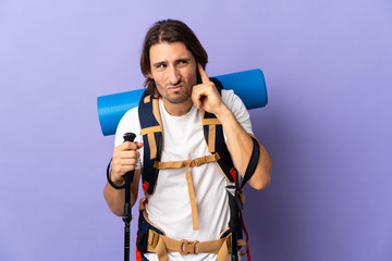 Young mountaineer man with a big backpack over isolated background frustrated and covering ears