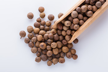 fresh spicy peppers allspice on white acrylic background