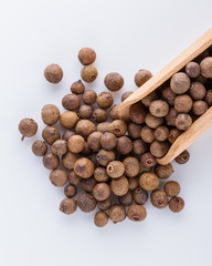 fresh spicy peppers allspice on white acrylic background