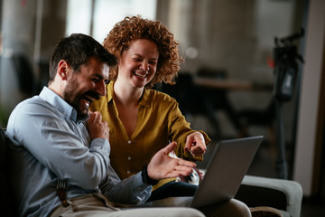 Businesswoman and businessman discussing work in office. Two friends in working together.