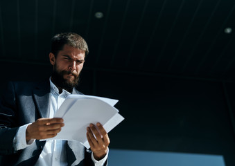 Business man outdoors with documents in hands near building official lifestyle