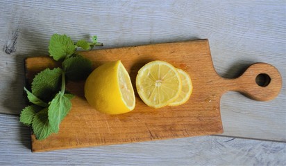 
lemon with mint on a wooden board