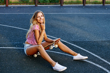 Summer portrit of stylish girl with skateboard