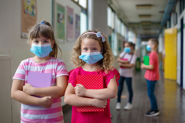 Elementary school children learn with masks on their faces