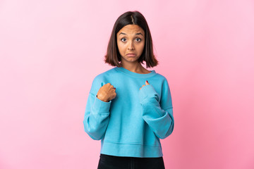 Young latin woman isolated on pink background with surprise facial expression