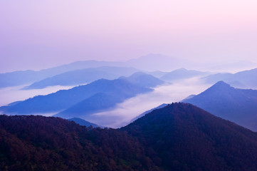 The dreaming blue mountainscape  with misty and foggy at dawn.