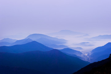 Naklejka na ściany i meble The dreaming blue mountainscape with misty and foggy at dawn.