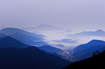 The dreaming blue mountainscape  with misty and foggy at dawn.