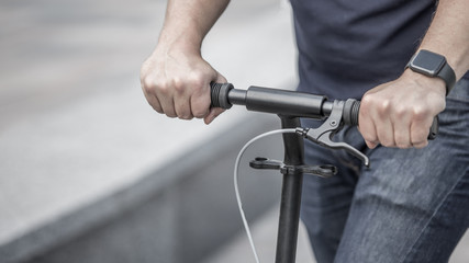 Businessman on thr street with kick scooter
