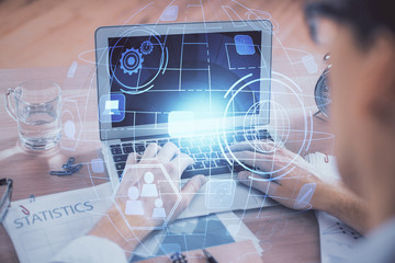 Social network theme hologram with businessman working on computer on background. Concept of world wide web. Double exposure.