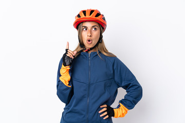 Young hispanic cyclist woman isolated on white background thinking an idea pointing the finger up