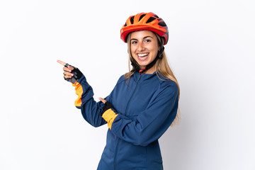Young hispanic cyclist woman isolated on white background pointing finger to the side
