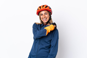 Young hispanic cyclist woman isolated on white background celebrating a victory