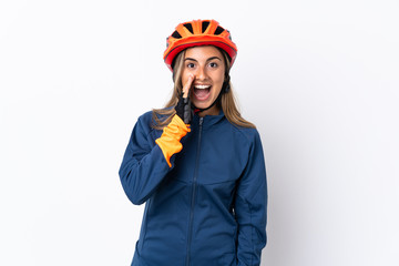 Young hispanic cyclist woman isolated on white background with surprise and shocked facial expression