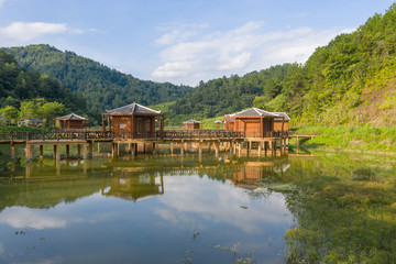 Fototapeta na wymiar Landscape of wooden houses and pavilions on the pond
