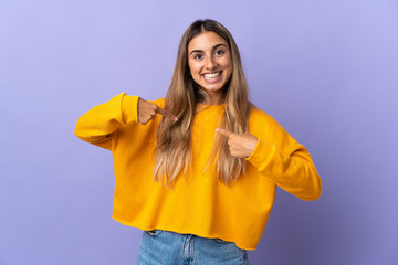 Young hispanic woman over isolated purple background with surprise facial expression
