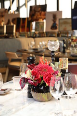 Red flowers in a vase on a table for an event.
