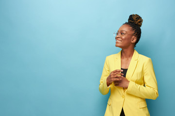 portrait photo of dark-skinned beautiful girl on a blue background in a yellow jacket, transparent...