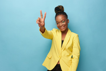 portrait photo of dark-skinned beautiful girl on a blue background in a yellow jacket, transparent...