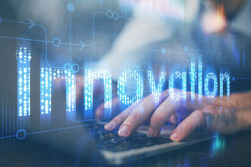 Multi exposure of data internet theme hologram with man working on computer on background. Concept of innovation.