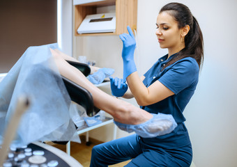Female gynecologist and patient in chair, exam