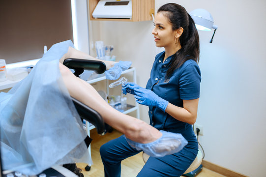 Female gynecologist in uniform with dilator