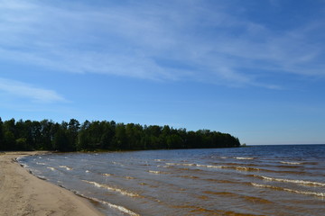 sandy shore of the Northern lake on a Sunny day