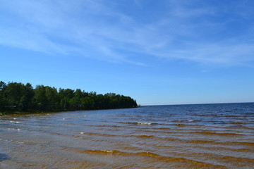 sandy shore of the Northern lake on a Sunny day