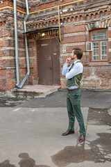 Fototapeta premium a man stands near a brick house