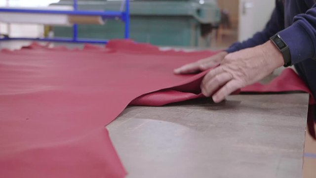 Closeup on a large red piece of leather, slowmotion