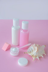 White and pink cosmetic bottles on rose background. Blank label for brand mockup. Concept of natural organic cosmetics, skin care