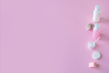 Pink background, beauty salon mockup. Cosmetic bottle containers with blank branding labels. Copy space, pastel colors. Natural organic cosmetics concept