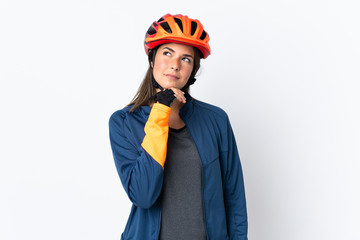 Young cyclist brazilian girl isolated on white  background and looking up