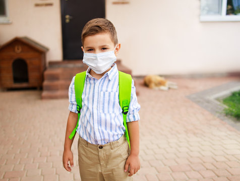 Schoolboy Going To School And Wearing Medical Mask. Back To School Concept After Reopening.