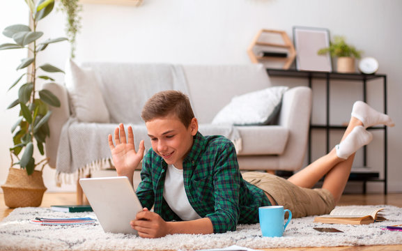 Schooler Having Videochat On Digital Tablet From Home