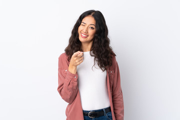 Spanish Chinese woman over isolated white background points finger at you
