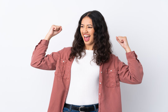 Spanish Chinese woman over isolated white background celebrating a victory