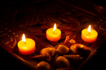 candles are lit on a wooden table