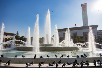 Casablanca Morocco Place Mohammed V fountain 12/31/2019 water spouts and pigeons - obrazy, fototapety, plakaty