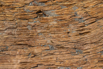 Naklejka premium The stone rock is brown slate. Natural texture in natural light.