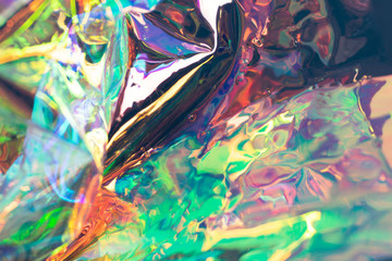 Multicolored defocused holographic background. Wrinkled fluid foil texture. Soft focus pearlescent...