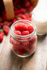 Ripe juicy raspberries in jar. Selective focus. Shallow depth of field.