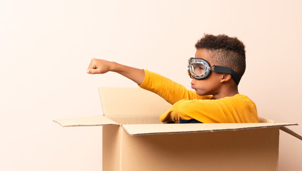 African American boy  with aviator hat over isolated background © luismolinero