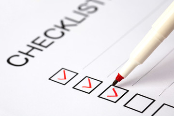 Fototapeta premium red pen marking on checklist box